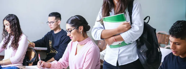Get settled back in with these tips and tricks Student walking through classroom between other students
