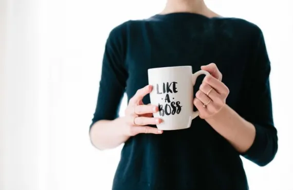 Woman holding a mug that says "Like a Boss"
