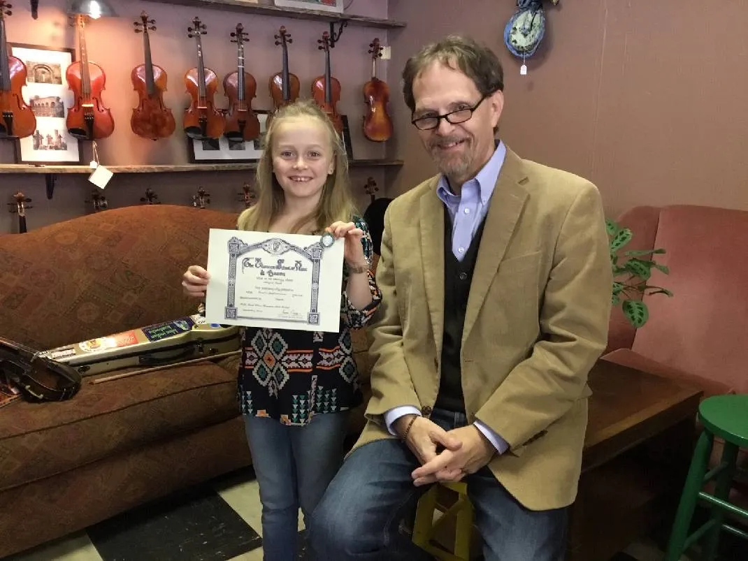 ten year old Abi Snell is accompanied by Griffith College lecturer, Tom Morley Photo Credit: Chattanooga Times Free Press ten year old Abi Snell is accompanied by Griffith College lecturer, Tom Morley Photo Credit: Chattanooga Times Free Press