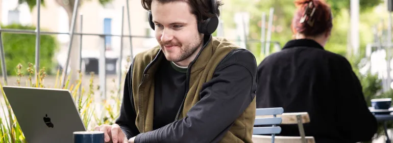 Blended Student working on college work outside Cafe