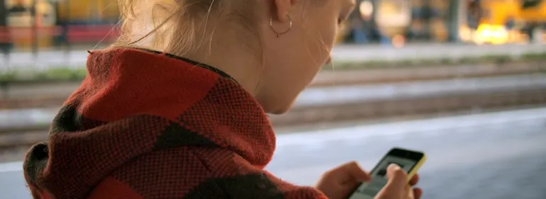 Reaching out for help is simple. Young woman looking at her phone screen