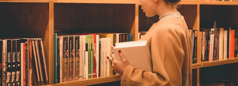 Our library is home to numerous resources Student browsing in the library