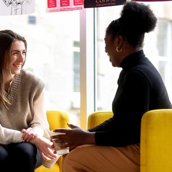 Law students chatting at yellow seats