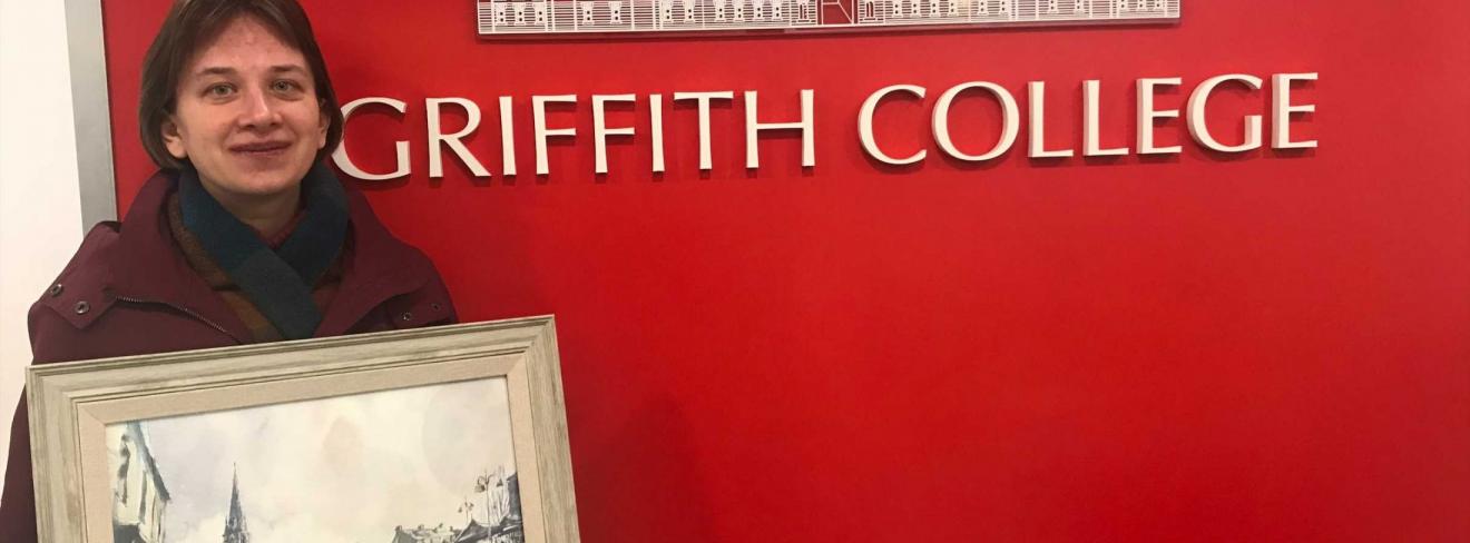 Tetiana Milshyna and her painting at Griffith College Cork Tetiana Milshyna and her painting at Griffith College Cork