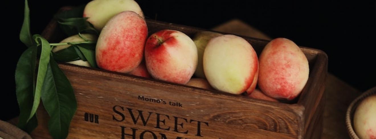 Time for autumn colours! A box of fruit against a dark background