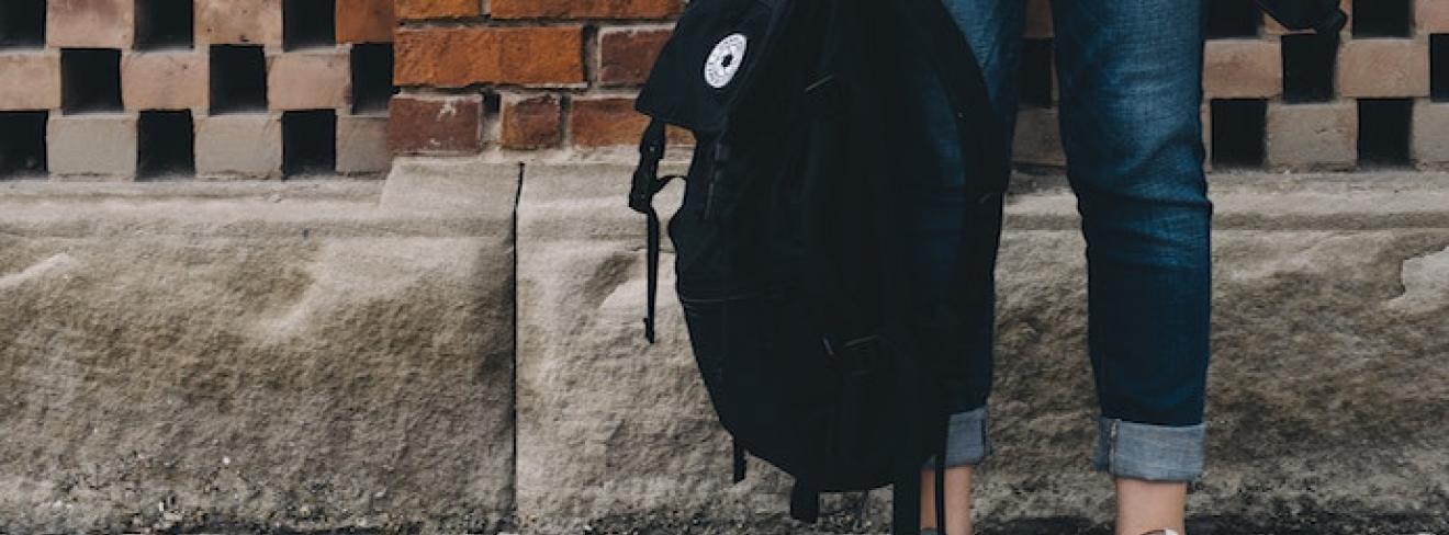 Student holding rucksack Student holding rucksack