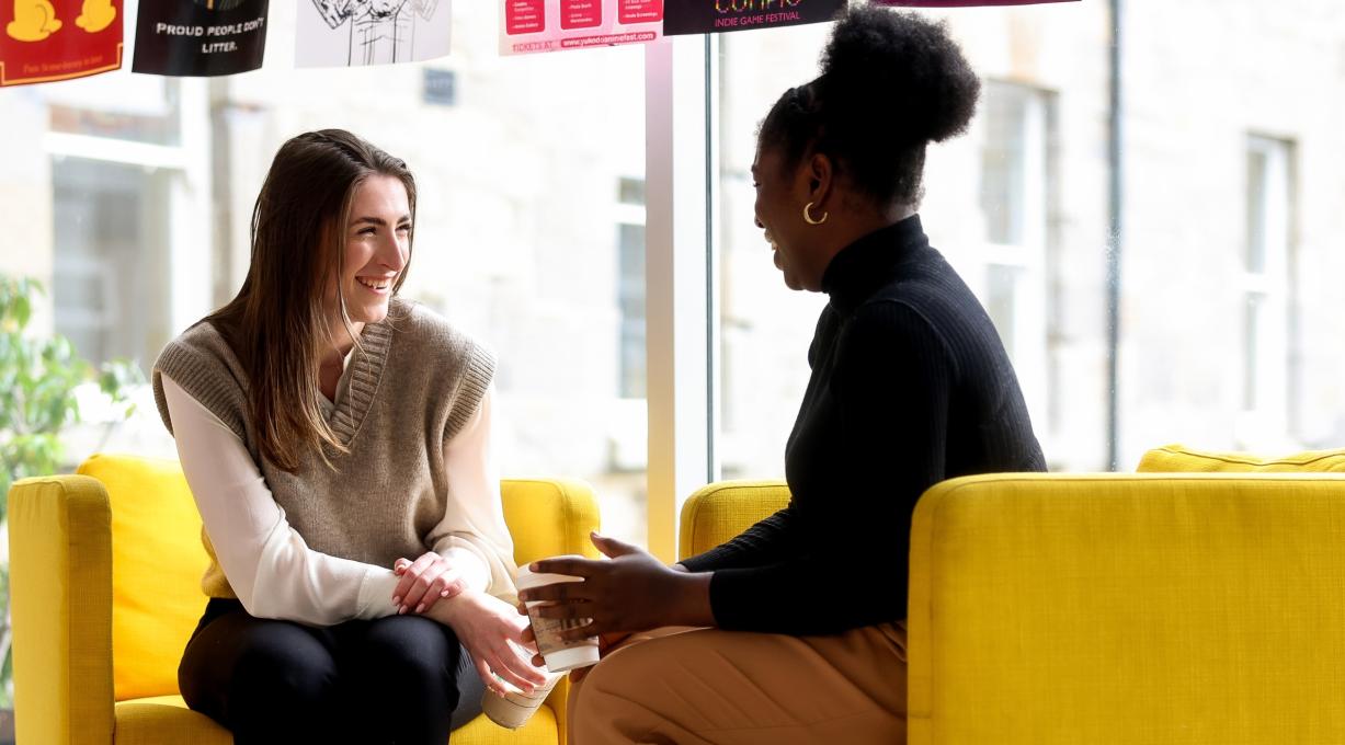 Law students chatting at yellow seats